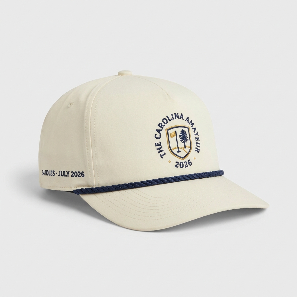 Style 1115 performance rope cap — cream laser-perforated microfiber, navy braided rope, flat-embroidered golf-club crest